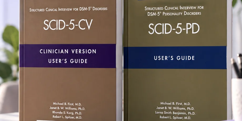 SCID-5-CV and SCID-5-PD user guides standing on a desk