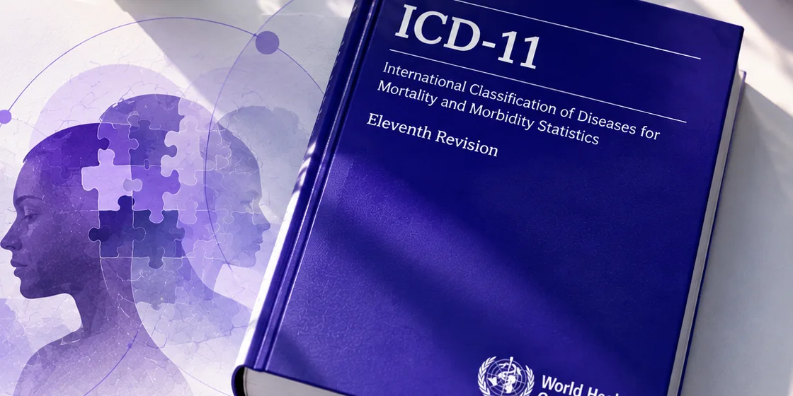 ICD-11 manual on a desk next to an illustration of overlapping head silhouettes