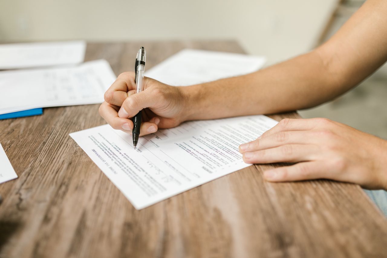 Trainee completing a clinical interview form during a structured interviewing course
